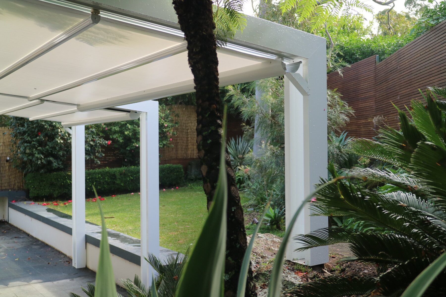 Clean white framing within a landscaped garden
